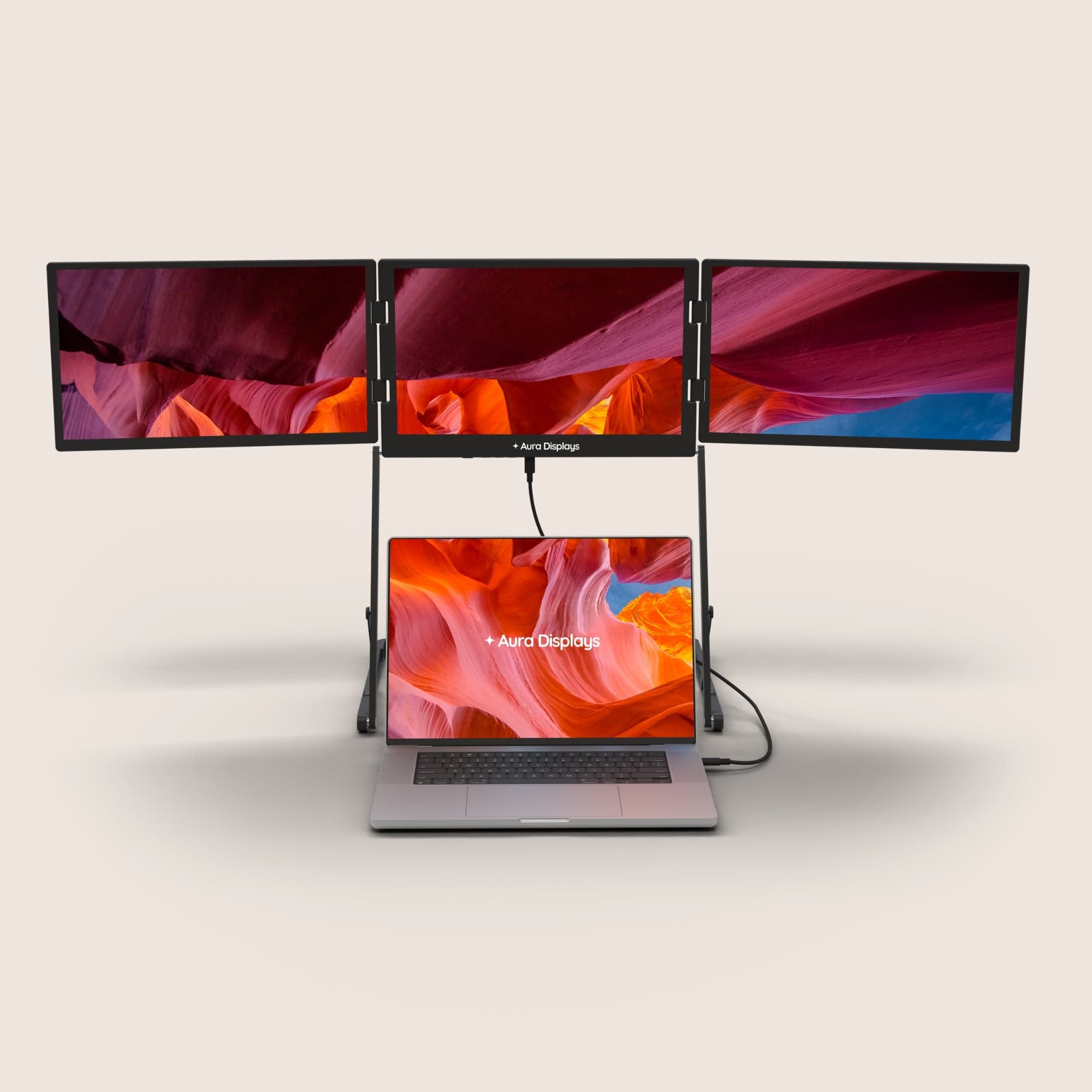 Aura Displays Triple Aero Pro Max extended around a laptop